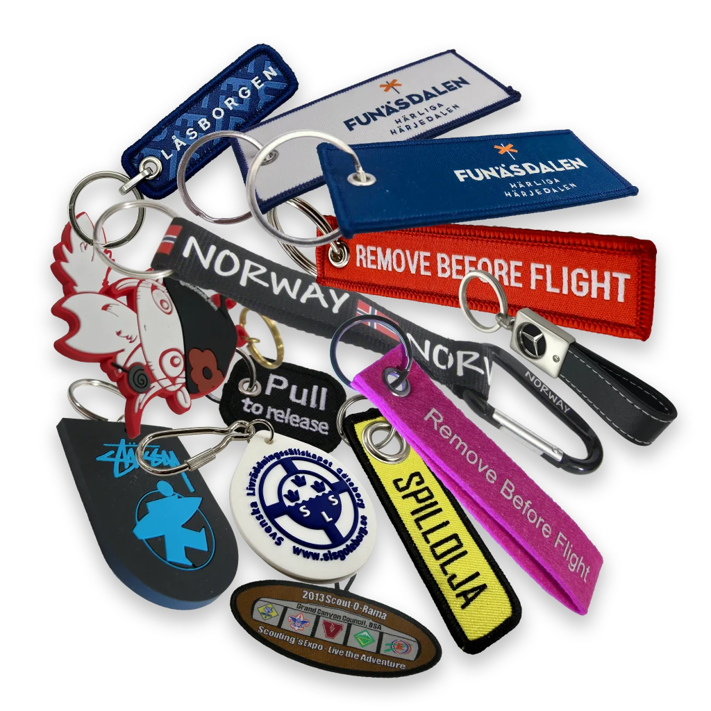Nyckelringar i tyg, gummi, läder och andra material med logotyper och andra designs.